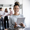 Portrait of an African American business woman working online at the office using a tablet computer